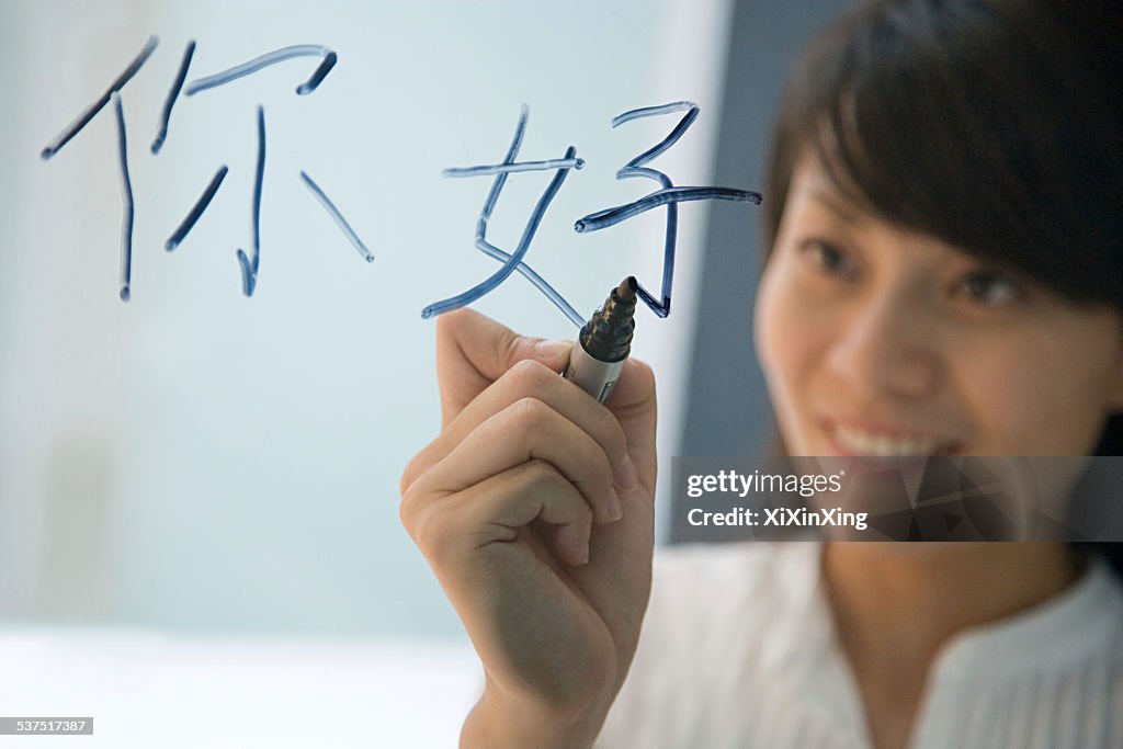 Woman writing hello in chinese