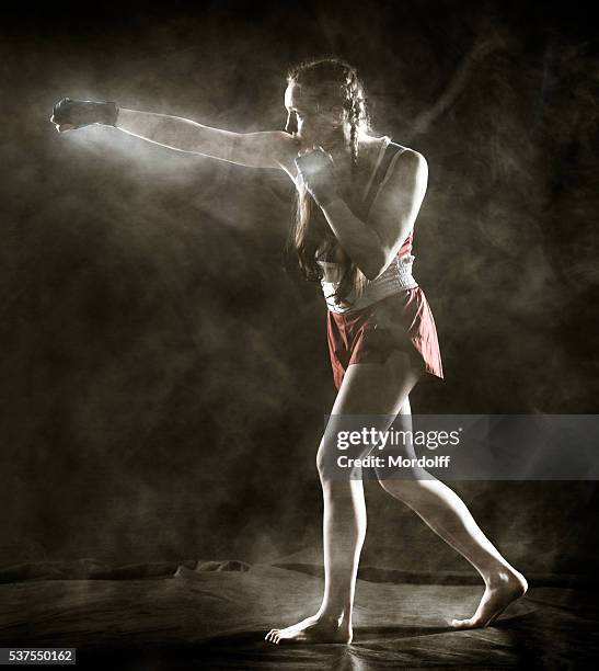 full-length portrait girl boxer in fighting stance - boxing womens stock pictures, royalty-free photos & images