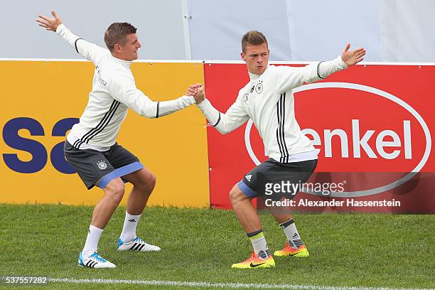 Toni Kroos of Germany warms up with his team mate Joshua Kimmich during a training session at stadio communale on day 10 of the German national team...