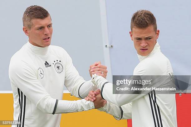 Toni Kroos of Germany warms up with his team mate Joshua Kimmich during a training session at stadio communale on day 10 of the German national team...