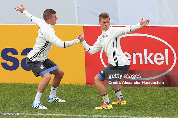 Toni Kroos of Germany warms up with his team mate Joshua Kimmich during a training session at stadio communale on day 10 of the German national team...