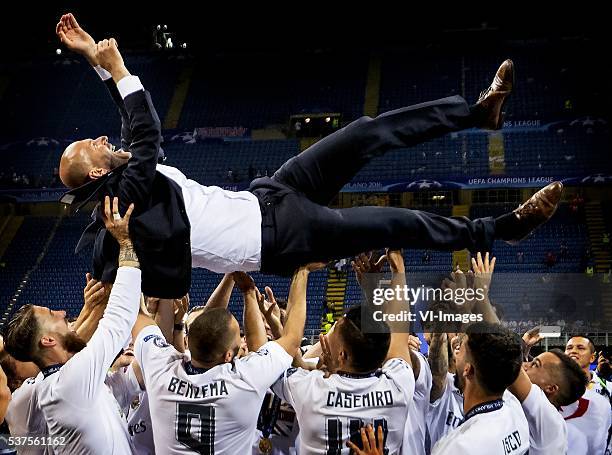 Real Madrid coach Zinedine Zidane is thrown in the air by his players after winning the Champions League final during the UEFA Champions League final...