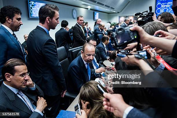 Khalid Al-Falih, Saudi Arabia's minister of energy and industry, center, sits surrounded by journalists ahead of the 169th Organization of Petroleum...