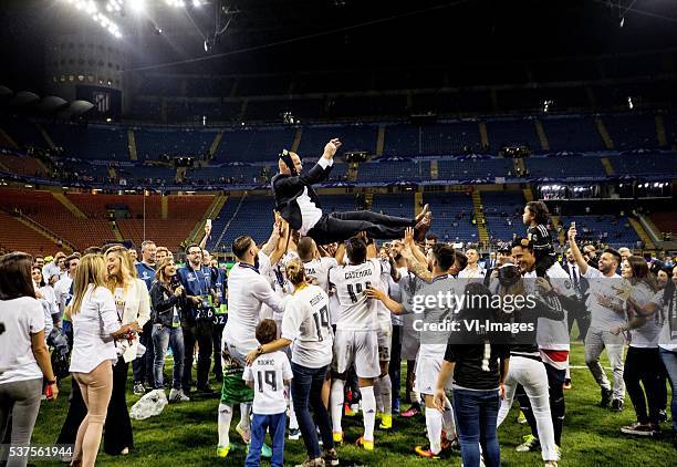 Real Madrid coach Zinedine Zidane is thrown in the air by his players after winning the Champions League final during the UEFA Champions League final...