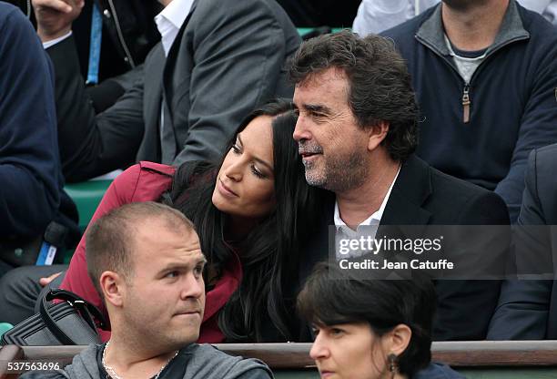 Arnaud Lagardere and his wife Jade Lagardere cheer for their friend Richard Gasquet of France against Andy Murray of Great Britain during day 11 of...