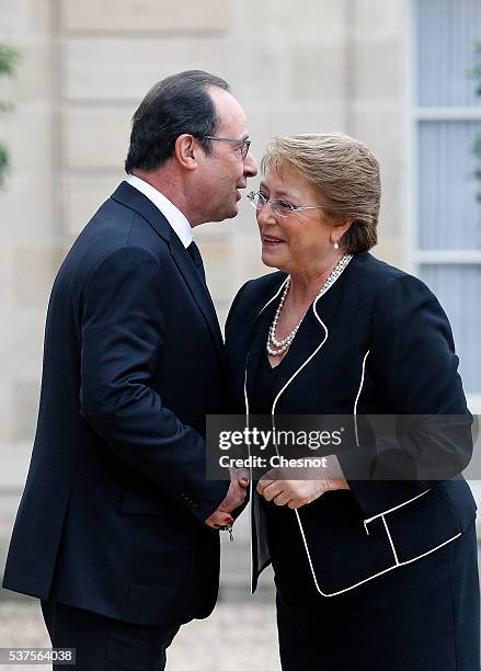 French President Francois Hollande welcomes President of Chile Michelle Bachelet prior to attend a meeting at the Elysee Presidential Palace on June...