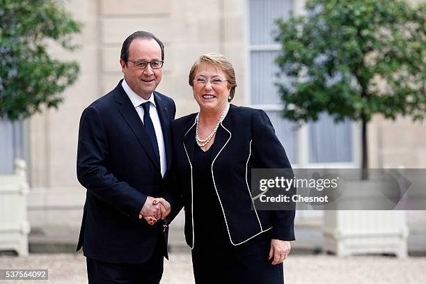 French President Francois Hollande welcomes President of Chile Michelle Bachelet prior to attend a meeting at the Elysee Presidential Palace on June...