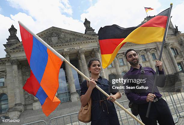 Activists hold up Armenian and German flags outside the Reichstag after parliamentarians at the Bundestag approved a resolution to recognize the 1915...