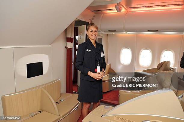 An Air France Crew member poses in the first class onboard the new Airbus A380 superjumbo passenger jet as it parks on the tarmac of the Airbus plant...