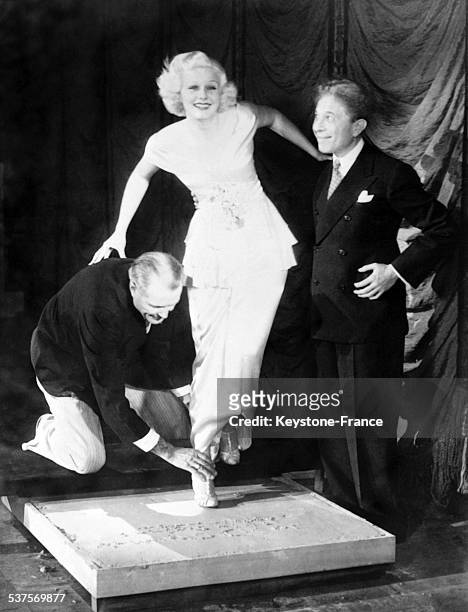 Sid Grauman's Chinese Theatre Director takes Jean Harlow's footprint, in Los Angeles, California, in 1933.