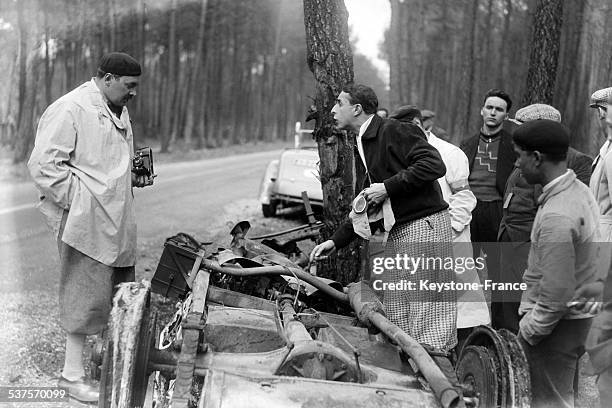 Romanian Prince Nicolas examines the debris of the car of Mrs Siko, competitor in the 24 Hours of Le Mans race, unscathed from an accident that...