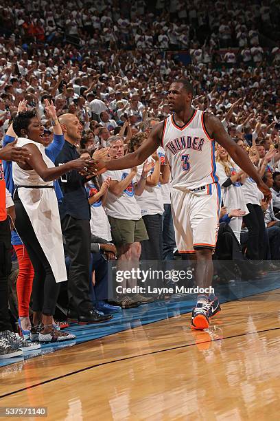 Dion Waiters of the Oklahoma City Thunder hits a shot and turns around to high five Wanda Durant in Game Four of the Western Conference Finals...