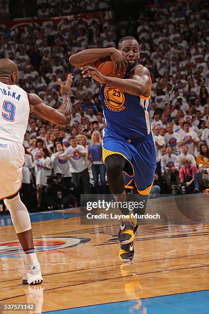 Draymond Green of the Golden State Warriors protects the ball as he drives to the basket against the Oklahoma City Thunder in Game Four of the...