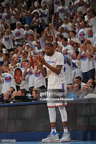 Kevin Durant of the Oklahoma City Thunder claps as he waits to get in the game against the Golden State Warriors in Game Four of the Western...