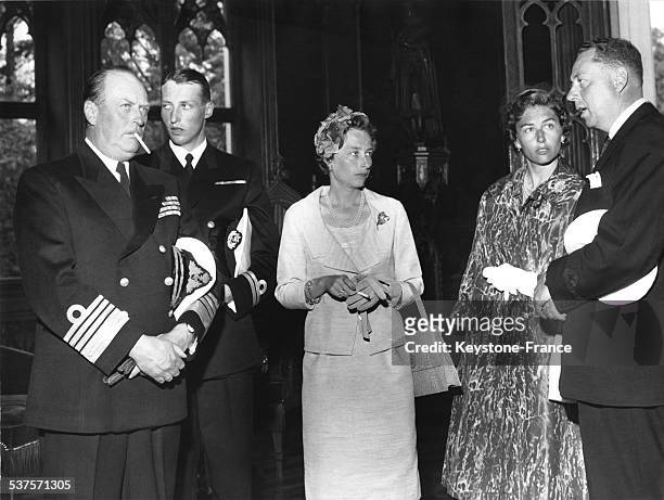 King Olav V, the crown Prince Harald, Princess Ragnhild and Princess Astrid at a reception at the American School, in 1960 in Oslo, Norway.