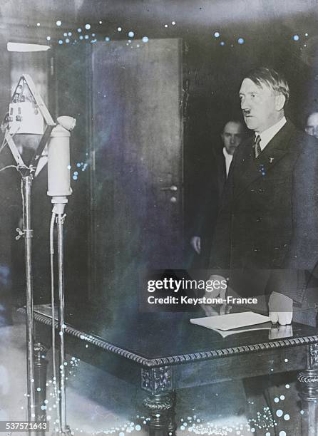 Chancellor Adolf Hitler during a speech broadcasted announcing the dissolution of the Reichstag and the withdrawal of Germany from the League of...