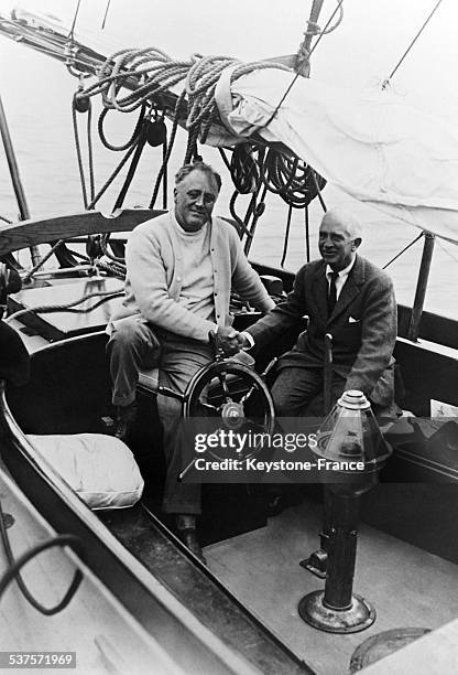 The President Franklin Delano Roosevelt aboard the yacht 'Amberjack' along with Norman Davis the head of his delegation on disarmament which makes...