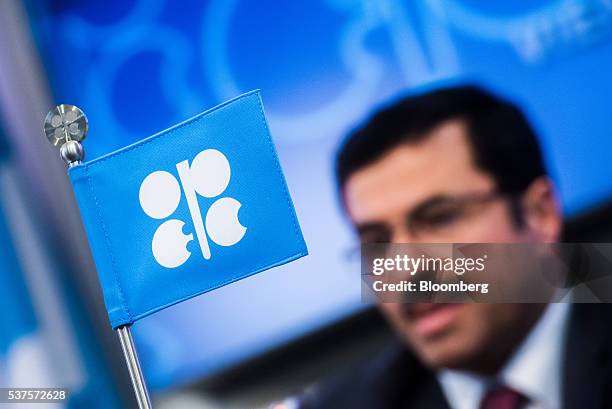 An OPEC flag stands on a desk as Mohammed Al-Sada, Qatar's minister of energy and industry and president of OPEC, speaks during a news conference...