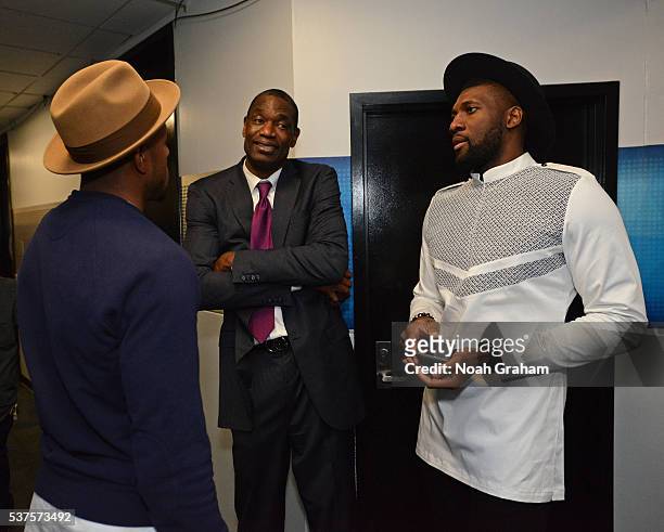 Legend, Dikembe Mutombo talks to Andre Iguodala and Festus Ezeli of the Golden State Warriors after Game Five of the Western Conference Finals...