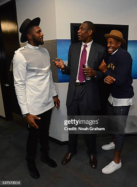 Legend, Dikembe Mutombo talks to Andre Iguodala and Festus Ezeli of the Golden State Warriors after Game Five of the Western Conference Finals...