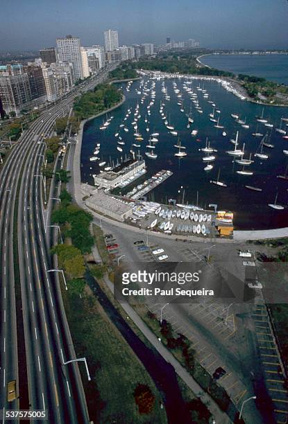 Aerial view looking north at Lakeshore Drive and Belmont Harbor,, Chicago, Illinois, 1980s.