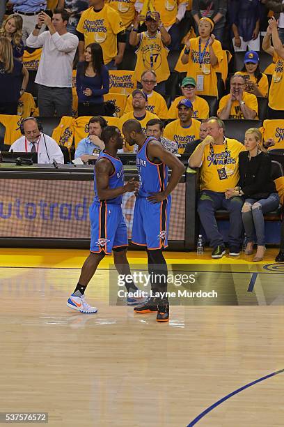 Dion Waiters and Serge Ibaka of the Oklahoma City Thunder talk in Game Five of the Western Conference Finals against the Golden State Warriors during...