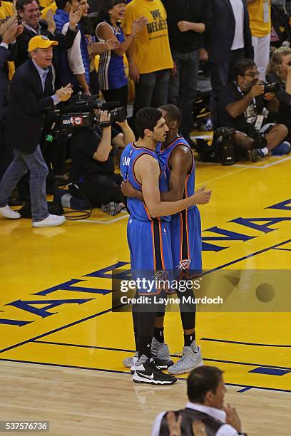 Enes Kanter and Kevin Durant of the Oklahoma City Thunder hug in Game Five of the Western Conference Finals against the Golden State Warriors during...