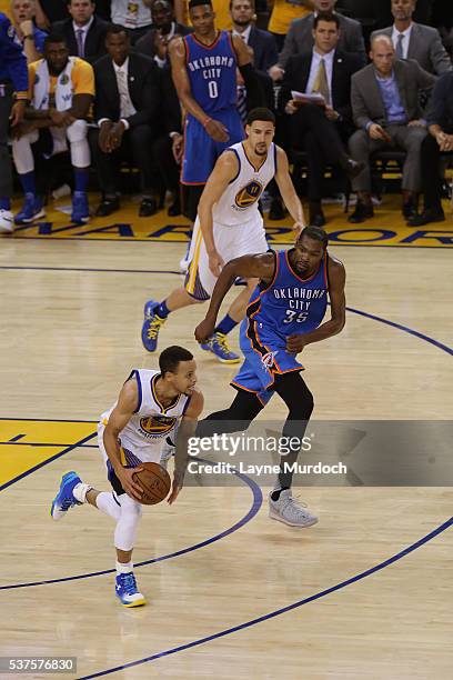 Stephen Curry of the Golden State Warriors dribbles the ball up court while guarded by Kevin Durant of the Oklahoma City Thunder in Game Five of the...