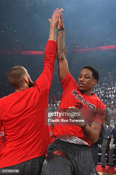 Jonas Valanciunas and DeMar DeRozan of the Toronto Raptors high five before Game Six of the NBA Eastern Conference Finals against the Cleveland...