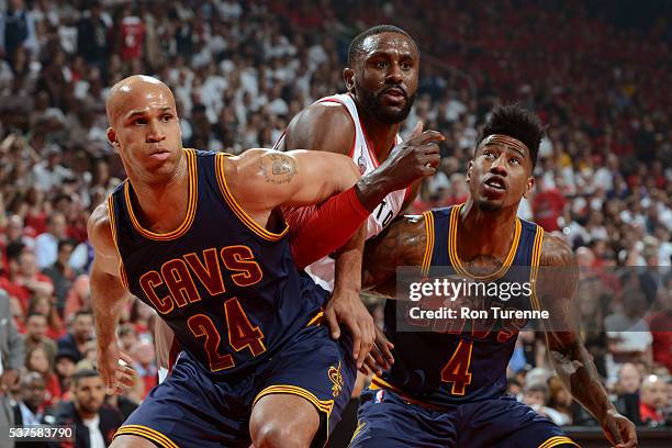 Richard Jefferson and Iman Shumpert of the Cleveland Cavaliers box out Patrick Patterson of the Toronto Raptors during Game Six of the NBA Eastern...