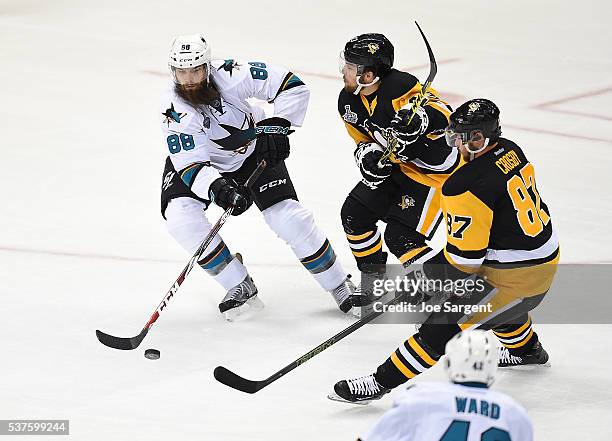 Brent Burns of the San Jose Sharks ,oves the puck in front of Conor Sheary and Sidney Crosby of the Pittsburgh Penguins during Game One of the 2016...