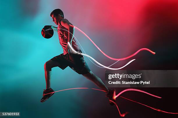 basketball player jumping,streaks of light - uniforme di basket foto e immagini stock