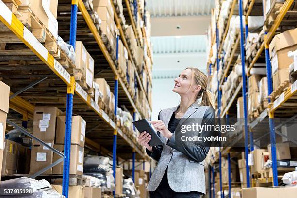 ordering with digital tablet in warehouse - megawinkel stockfoto's en -beelden