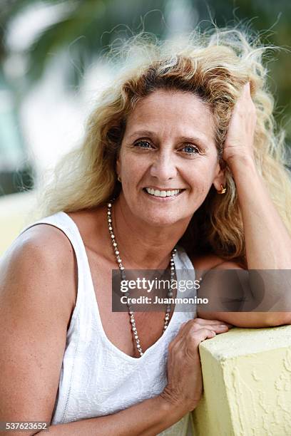 fifty something woman - hand in hair stock pictures, royalty-free photos & images