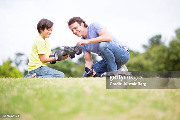 man and hs son playing with car - remote control car stock pictures, royalty-free photos & images