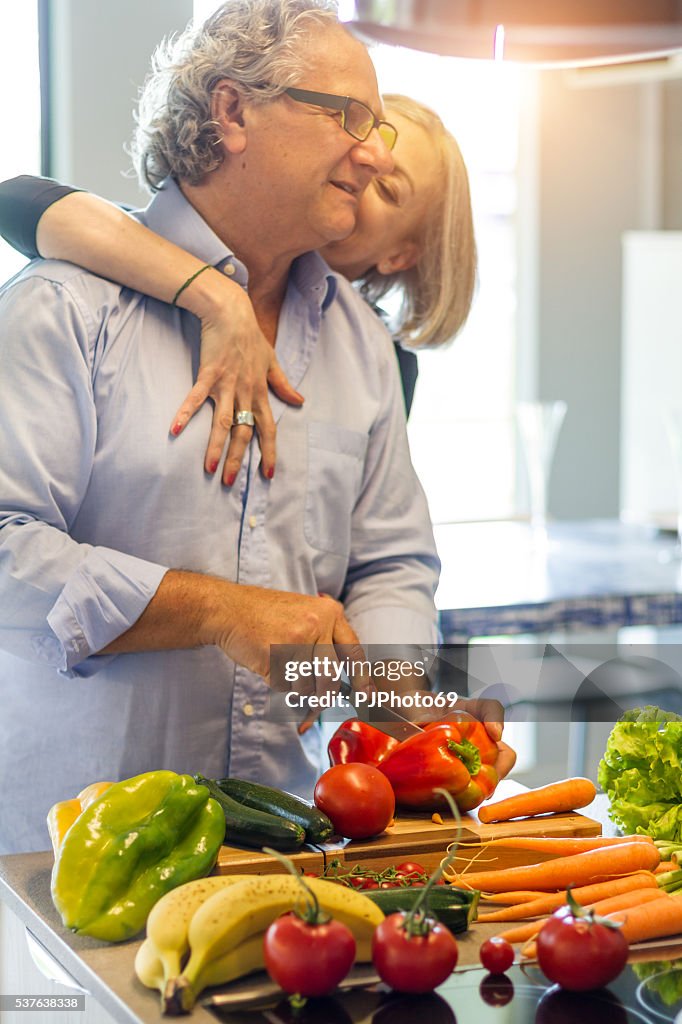 Couple of seniors in love cooking