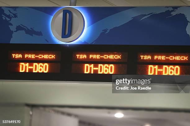 Sign indicates the way to the TSA PreCheck security point at Miami International Airport on June 2, 2016 in Miami, Florida. As the busy summer travel...