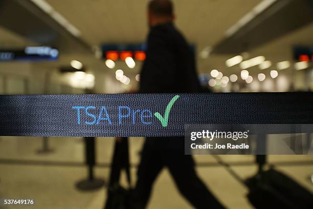 Travelers go through the TSA PreCheck security point at Miami International Airport on June 2, 2016 in Miami, Florida. As the busy summer travel...