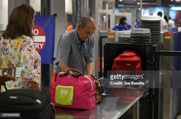 Travelers go through the TSA PreCheck security point at Miami International Airport on June 2, 2016 in Miami, Florida. As the busy summer travel...