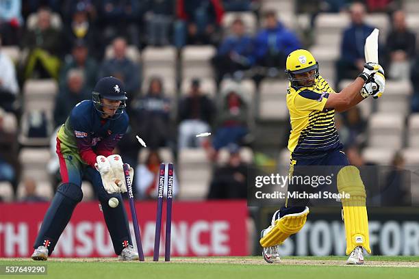 Shahid Afridi of Hampshire is bowled by Fabian Cowdrey as wicketkeeper Sam Billings of Kent looks on during the NatWest T20 Blast match between...