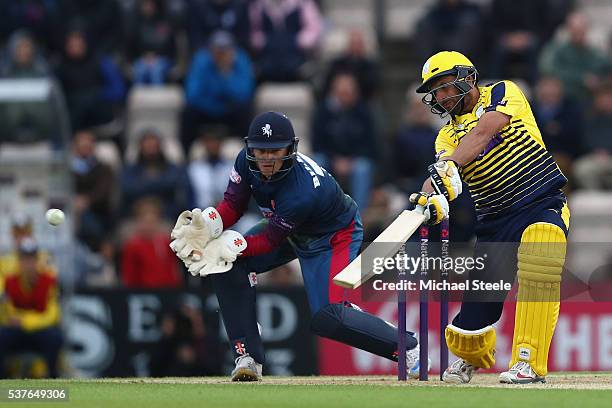 Shahid Afridi of Hampshire hits to the offside as wicketkeeper Sam Billings of Kent looks on during the NatWest T20 Blast match between Hampshire and...