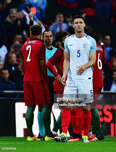 Bruno Alves of Portugal is shown a red card by referee Marco Guida and is sent off during the international friendly match between England and...