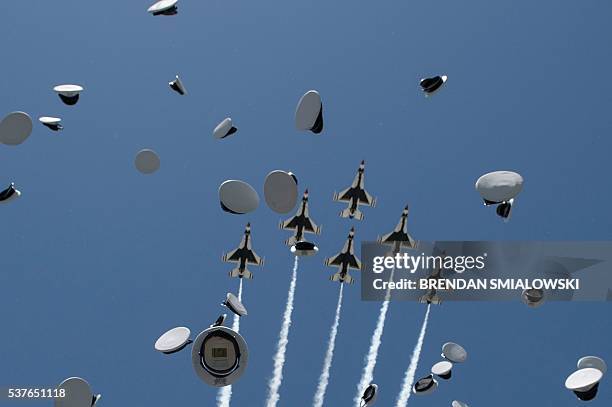 Cadets caps and Air Force Thunderbirds are seen during a graduation ceremony at the US Air Force Academy's Falcon Stadium June 2, 2016 in Colorado...