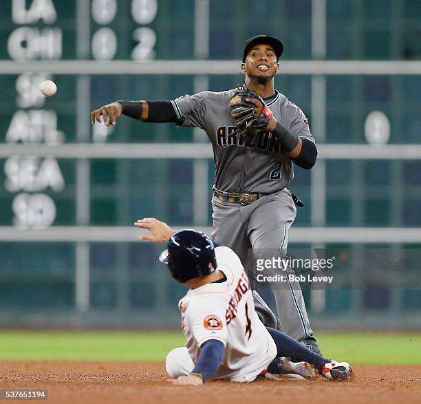 Jean Segura of the Arizona Diamondbacks throws over George Springer of the Houston Astros in the fourth inning at Minute Maid Park on June 2, 2016 in...