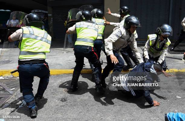 Security forces arrest a man protesting against the severe food and medicine shortages in Venezuela, in the surroundings of the Miraflores...