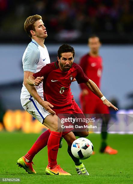 Joao Moutinho of Portugal takes on Eric Dier of England during the international friendly match between England and Portugal at Wembley Stadium on...