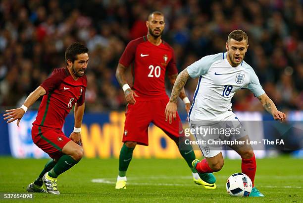 Joao Moutinho of Portugal closes down Jack Wilshere of England during the International Friendly match between England and Portugal at Wembley...