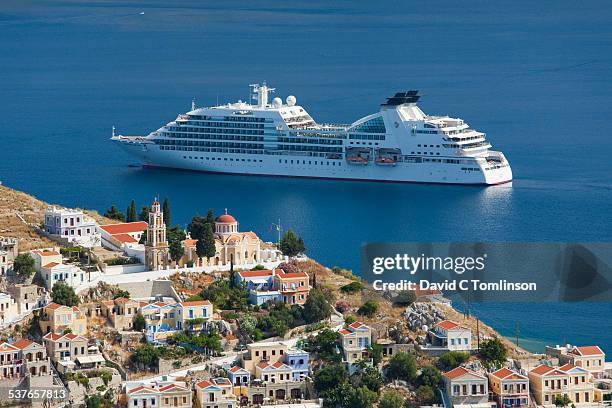 cruise ship in the bay, gialos, symi, greece - kreuzfahrtschiff stock-fotos und bilder