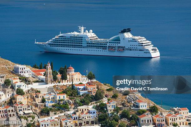 cruise ship in the bay, gialos, symi, greece - imbarcazione per passeggeri foto e immagini stock