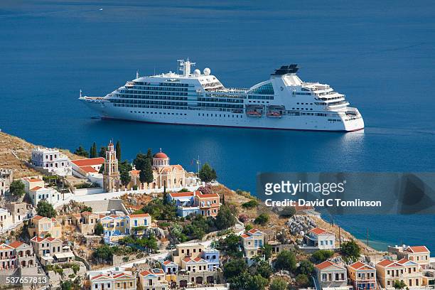 cruise ship in the bay, gialos, symi, greece - embarcação comercial imagens e fotografias de stock